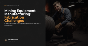 A man wearing work gloves and overalls crouches next to large metal machinery in a dimly lit workshop. Text on the left reads: "Mining Equipment Manufacturing: Fabrication Challenges. A guide from C.L. Dews & Sons.